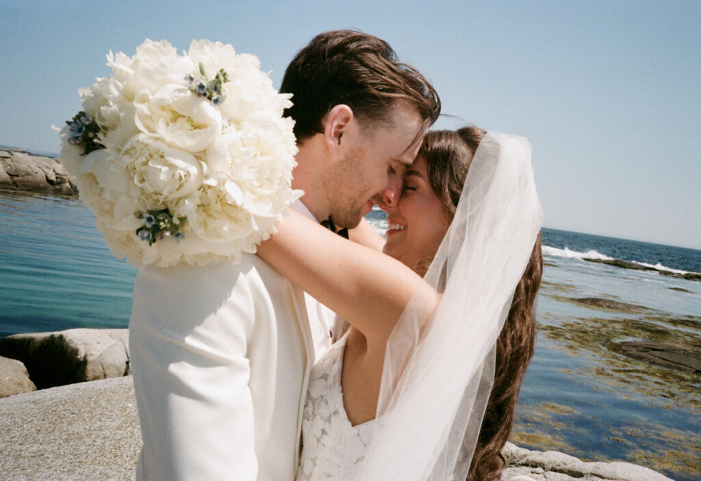 Wedding portraits at Peggy’s Cove lighthouse during Oceanstone Resort wedding