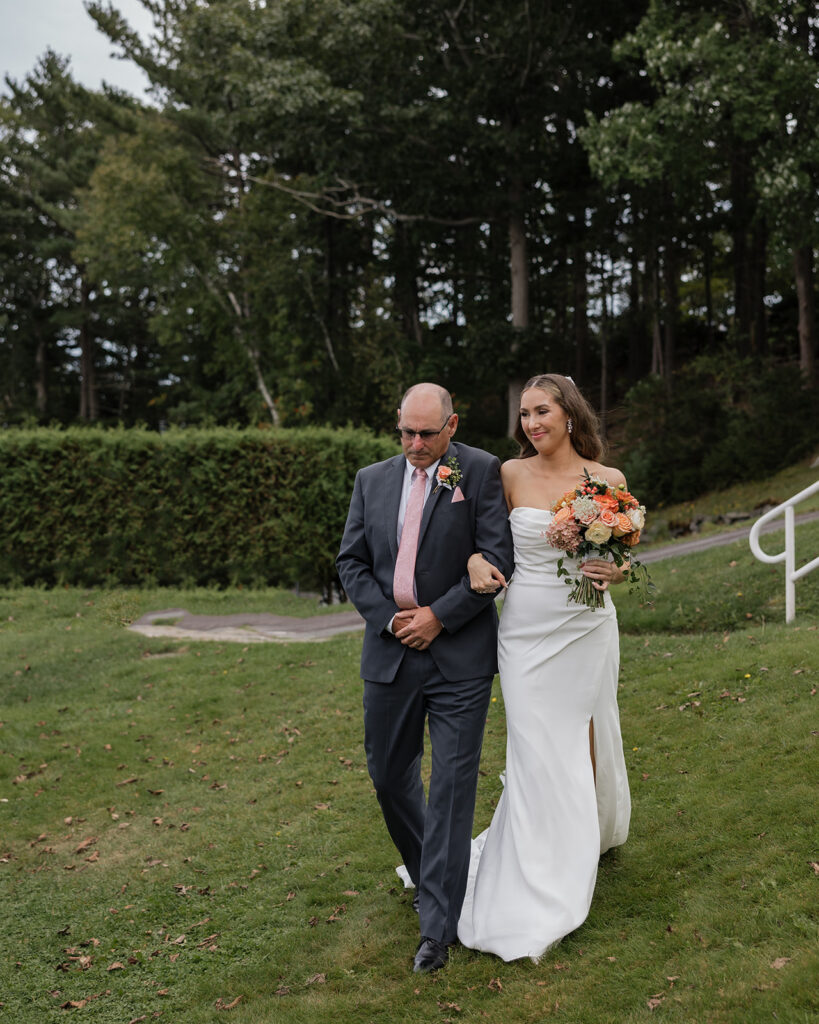 Bride walking through lush greenery at a private estate wedding in Nova Scotia