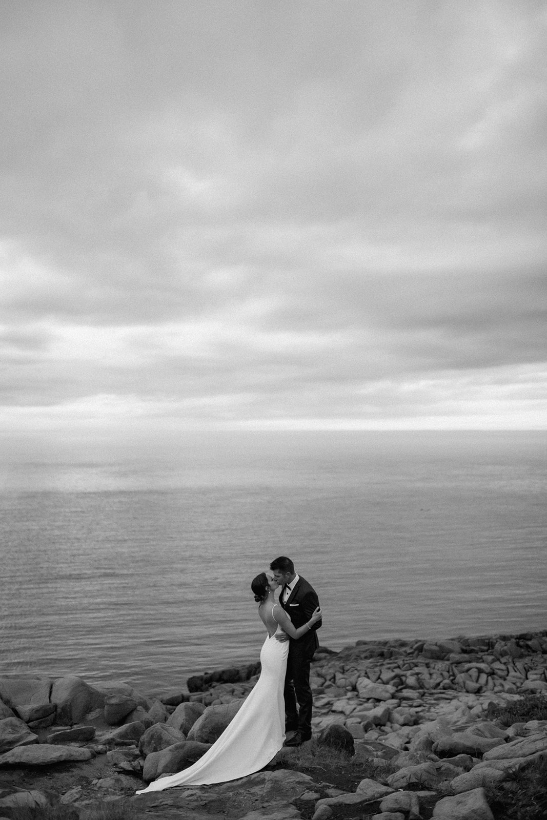 Couple embracing at sunset during a coastal Nova Scotia wedding