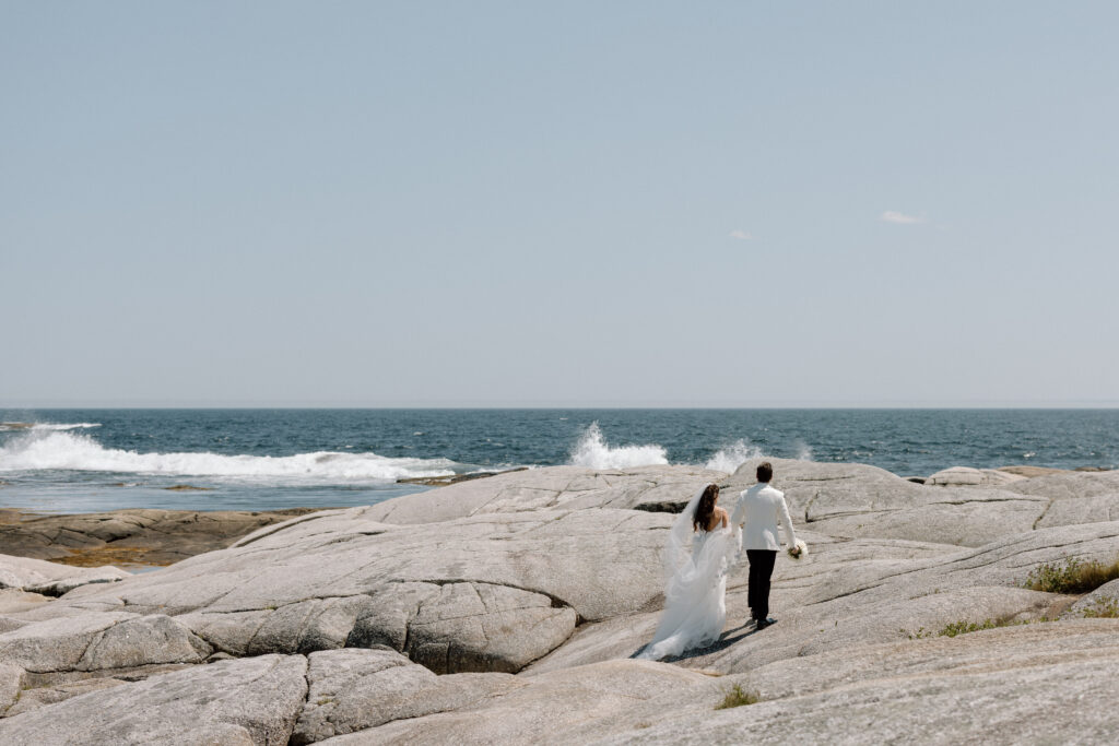 Bride and groom portraits on the rocks at Peggy’s Cove Nova Scotia