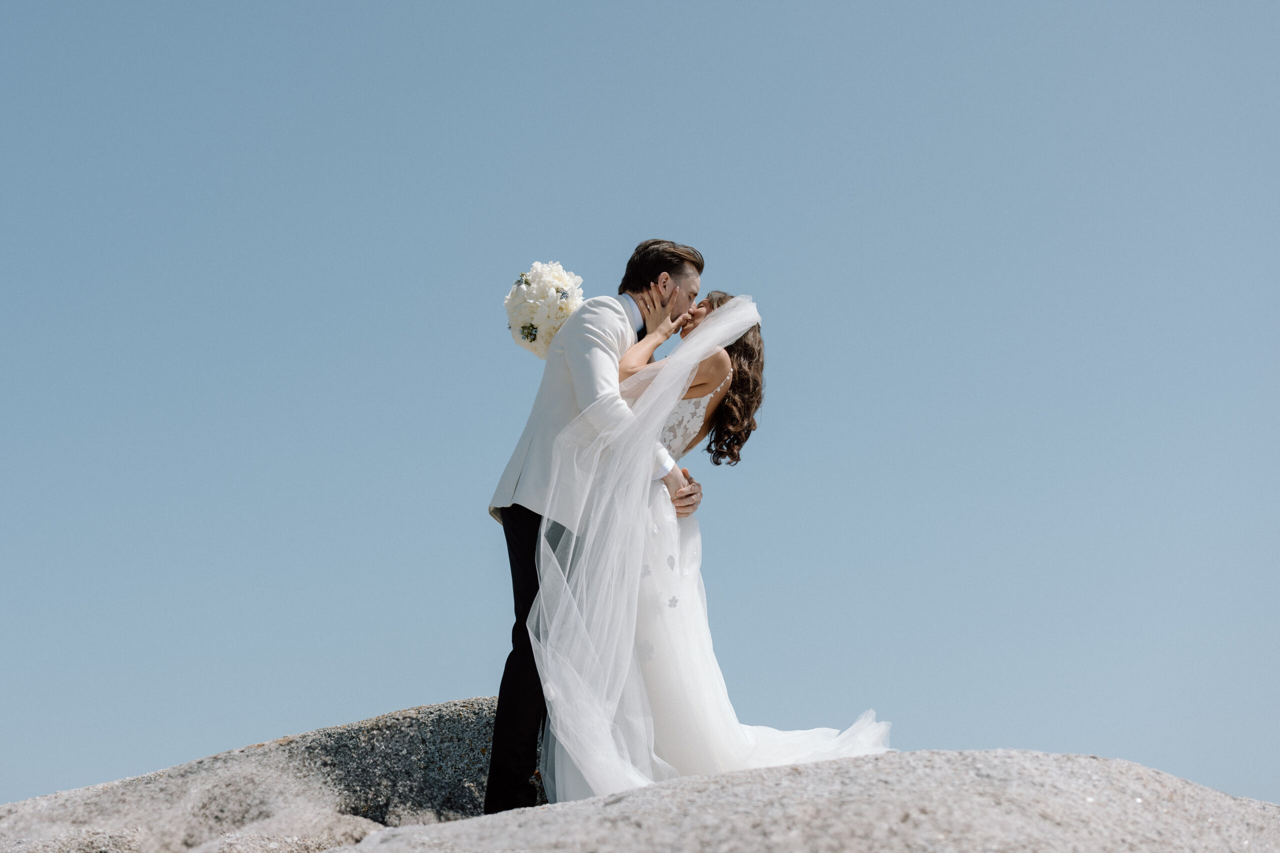 Couple photographed at Peggy’s Cove during Oceanstone Resort wedding day