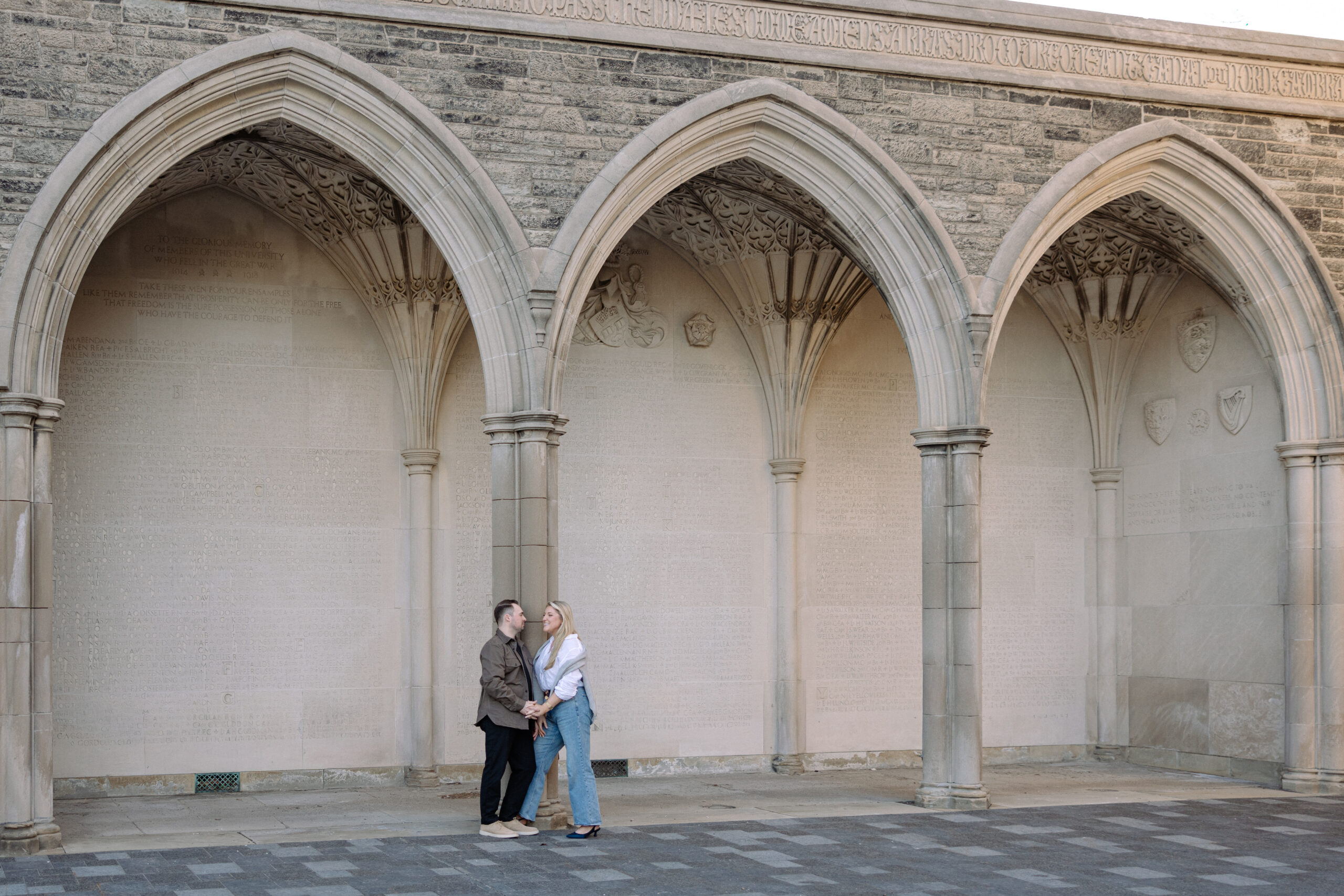 Intimate engagement portrait with soft light and historic architecture at University of Toronto