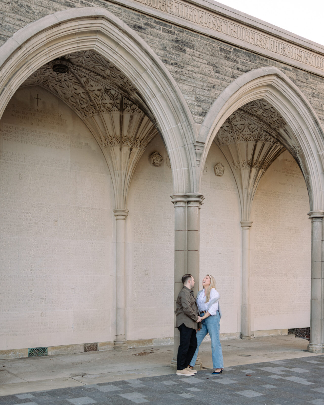 Intimate engagement portrait with soft light and historic architecture at University of Toronto