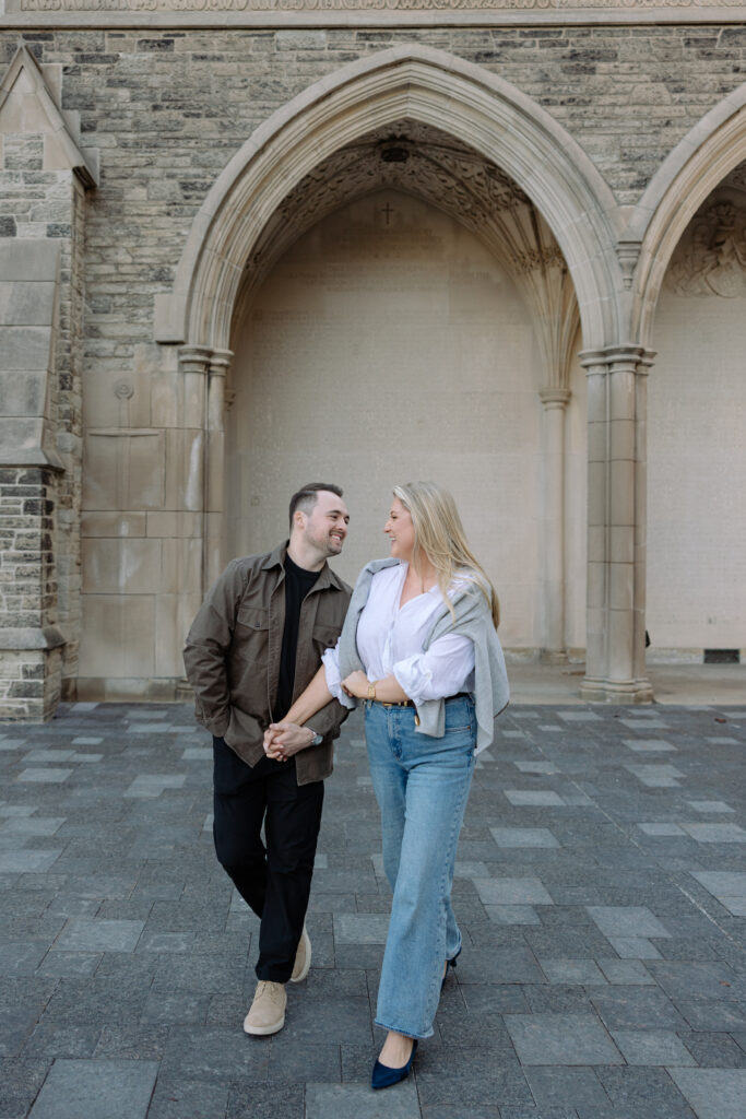 Intimate engagement portrait with soft light and historic architecture at University of Toronto