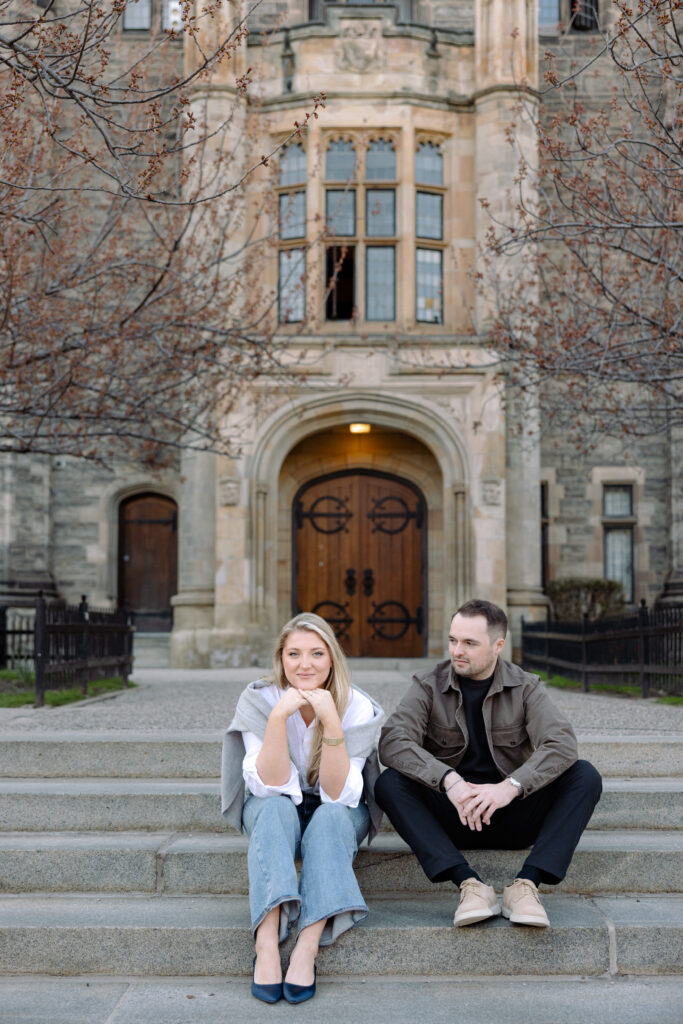 Intimate engagement portrait with soft light and historic architecture at University of Toronto