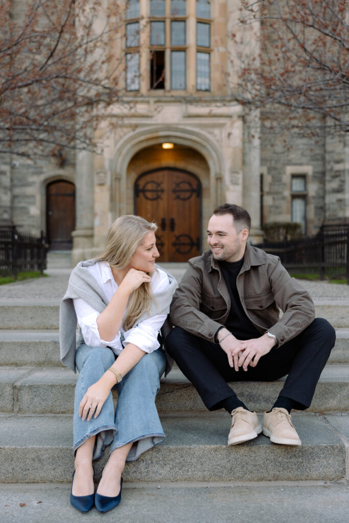 Intimate engagement portrait with soft light and historic architecture at University of Toronto