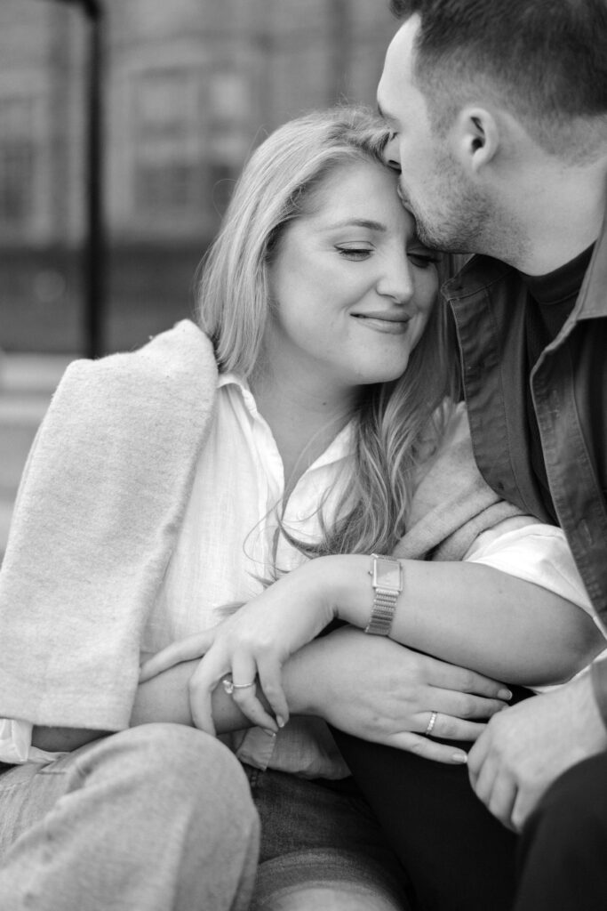 Intimate engagement portrait with soft light and historic architecture at University of Toronto