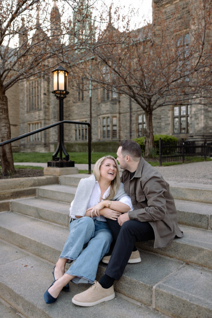 Couple embracing in front of gothic architecture at University of Toronto in Toronto Ontario