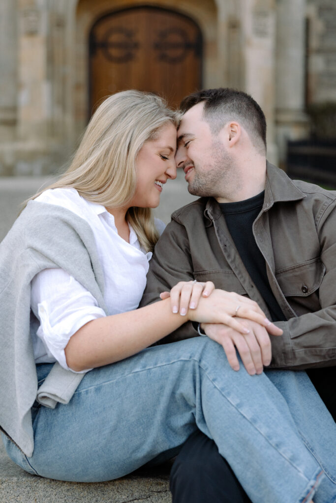 Couple embracing in front of gothic architecture at University of Toronto in Toronto Ontario