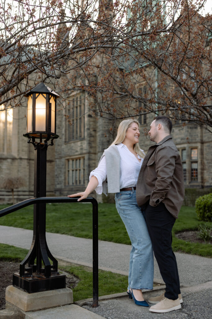 Intimate engagement portrait with soft light and historic architecture at University of Toronto