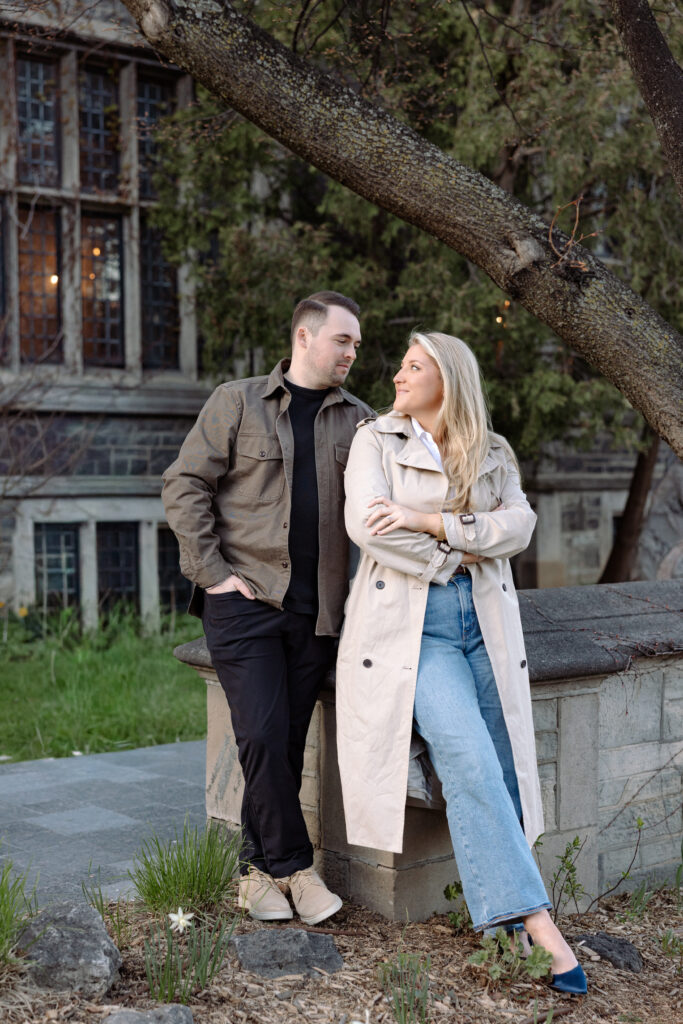 Intimate engagement portrait with soft light and historic architecture at University of Toronto